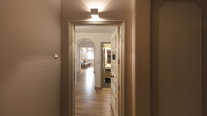 A hallway leading to a bedroom with a door on the right. - Karneadou34 · Stylish Kolonaki 2 Bdr apartment (Athens)
