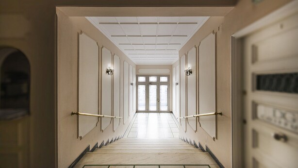 A long, narrow hallway with a marble floor, leading to a set of double doors at the end. - Karneadou34 · Stylish Kolonaki 2 Bdr apartment (Athens)