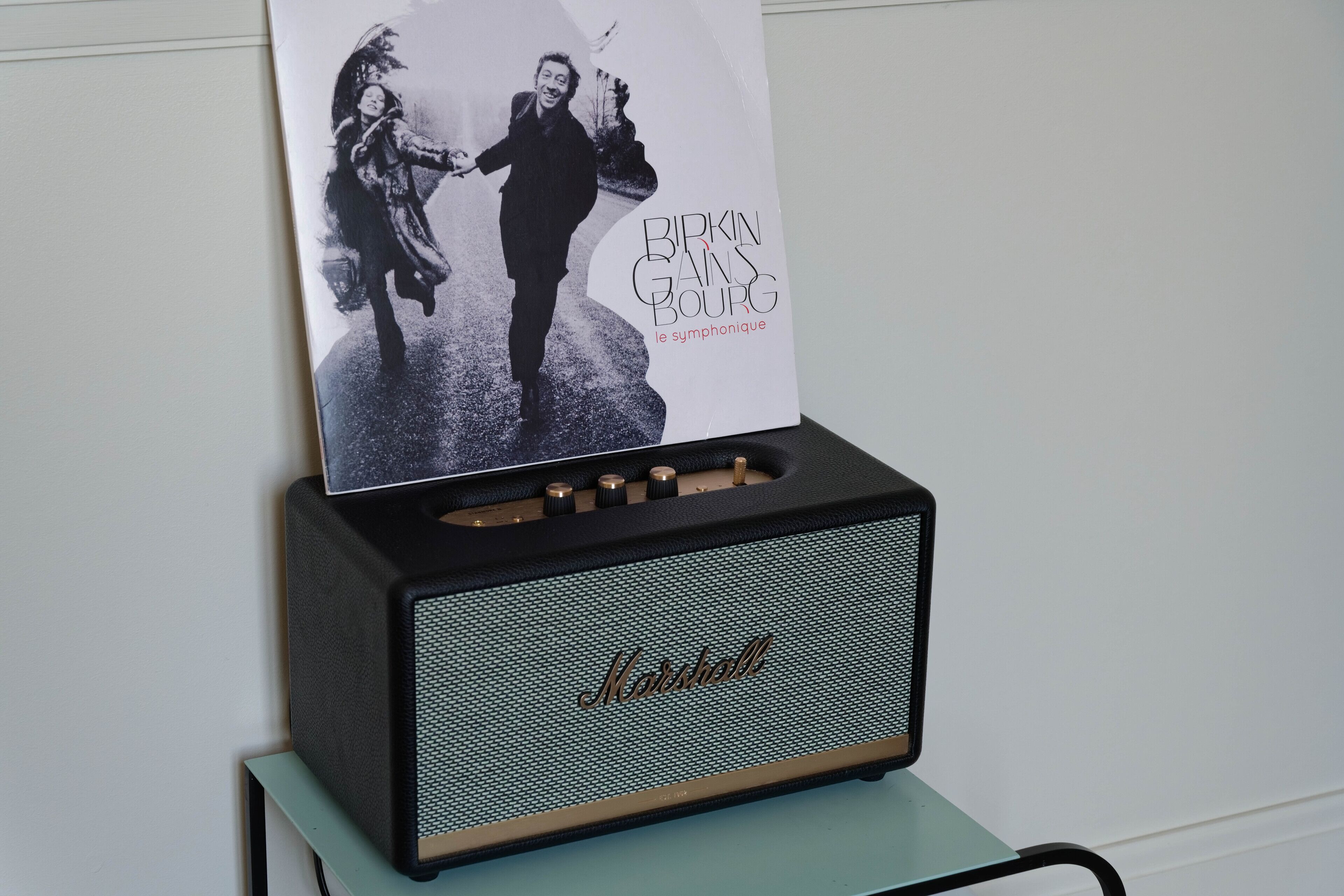 A Marshall amplifier with a poster of Birkin Gainsbourg on it.