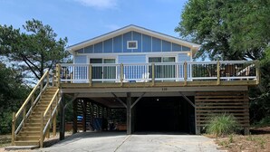 A two-story house with a balcony and a garage. - D110- Large Private Saltwater Pool, 3 Bedrooms and Only 600 Yards to Beach!! (Duck)