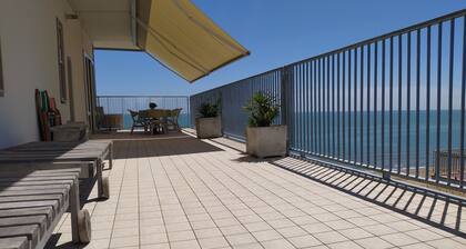 Apartment with large terrace right by the sea