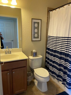 A bathroom with a sink, toilet, and a framed picture on the wall. - Treviso Bay 3rd Floor Acqua Ct. Condo Corner Unit with TPC Golf (Naples)