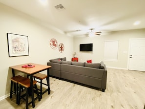 Cozy living space with a dining area, sofa, and flat-screen TV.
