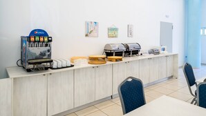 A breakfast bar with a Pepsi dispenser, coffee machines, and various breakfast items. - Santa Maria City Hotel (Rhodes)