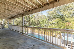 A wooden deck with a pool and hot tub, surrounded by trees. - Gone With The Wind - Duck, Gull's Flight, 325 Yds to Beach, Pool, Hot Tub, Pets OK, Flex Stays (Duck)
