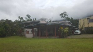A two-story house with a covered porch and a small attached garage.
