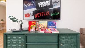 A green cabinet with a flat-screen TV displaying streaming service logos.