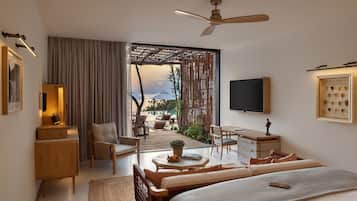 A modern bedroom with a bed, a desk, a chair, and a view of the outdoors.
