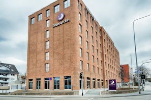 A brick building with 'Premier Inn' signage, multiple windows, and a visible entrance.