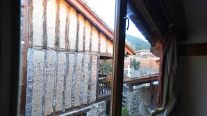 A rustic building with exposed wooden beams and a stone wall.