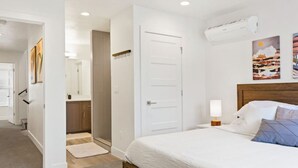 A bedroom with a bed, bedside lamp, and artwork on the wall. - Large Home Sleeps 16-Pool Perfect For Family Fun! (St. George)