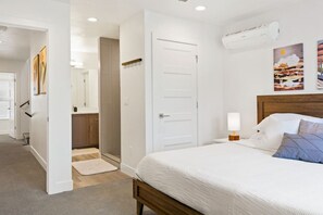 A bedroom with a bed, bedside lamp, and artwork on the wall. - Large Home Sleeps 16-Pool Perfect For Family Fun! (St. George)