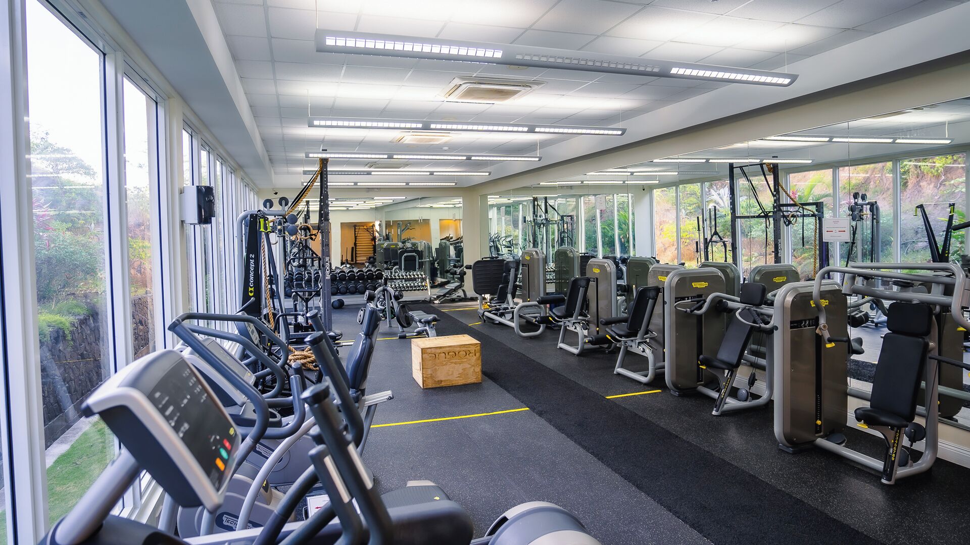 A gym with cardio machines, weight stations, and exercise equipment.