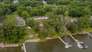 A lakeside property with a large house, a dock, and a swimming pool. - Beautiful Canandaigua Lake view - Family friendly! 4 Season Home - Fall Foliage! (Canandaigua)
