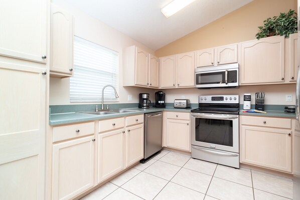 Enjoy cooking in this well-equipped kitchen with a stainless steel dishwasher, microwave, toaster, and oven.