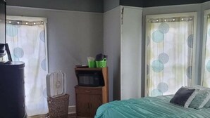 A bedroom with a bed, dresser, and a small cabinet. - #3 Bohemian Rest Place  (Watertown)
