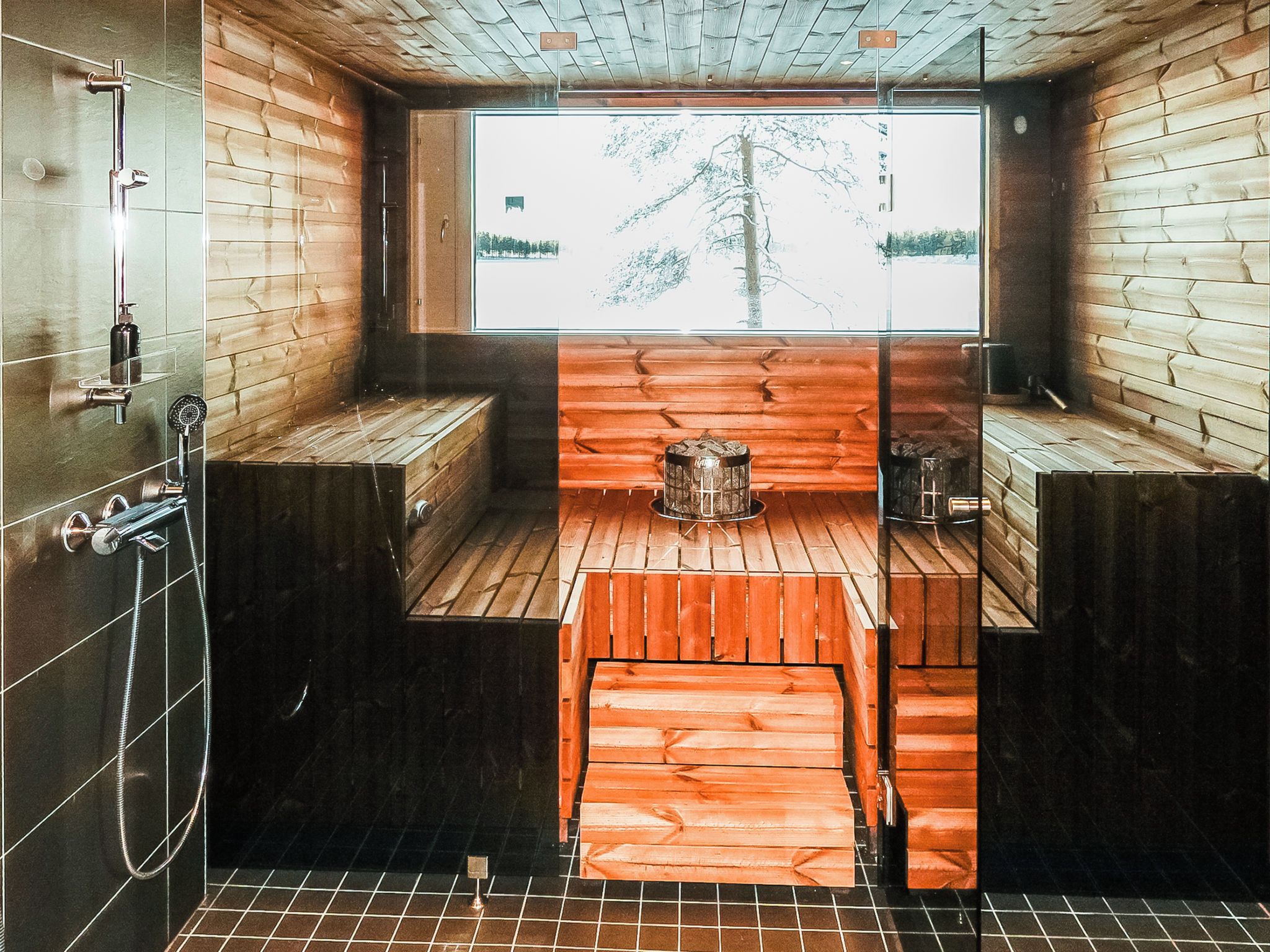 A modern bathroom with wooden walls, a large window, and a central bench.