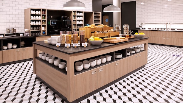 A modern kitchen with a central island, wooden cabinets, and a patterned floor. - Holiday Inn Express Offenburg by IHG (Offenburg)