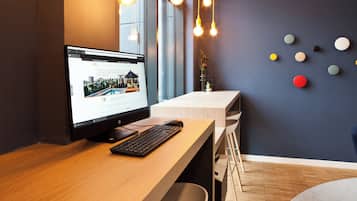 A modern office desk with a computer, keyboard, and mouse.