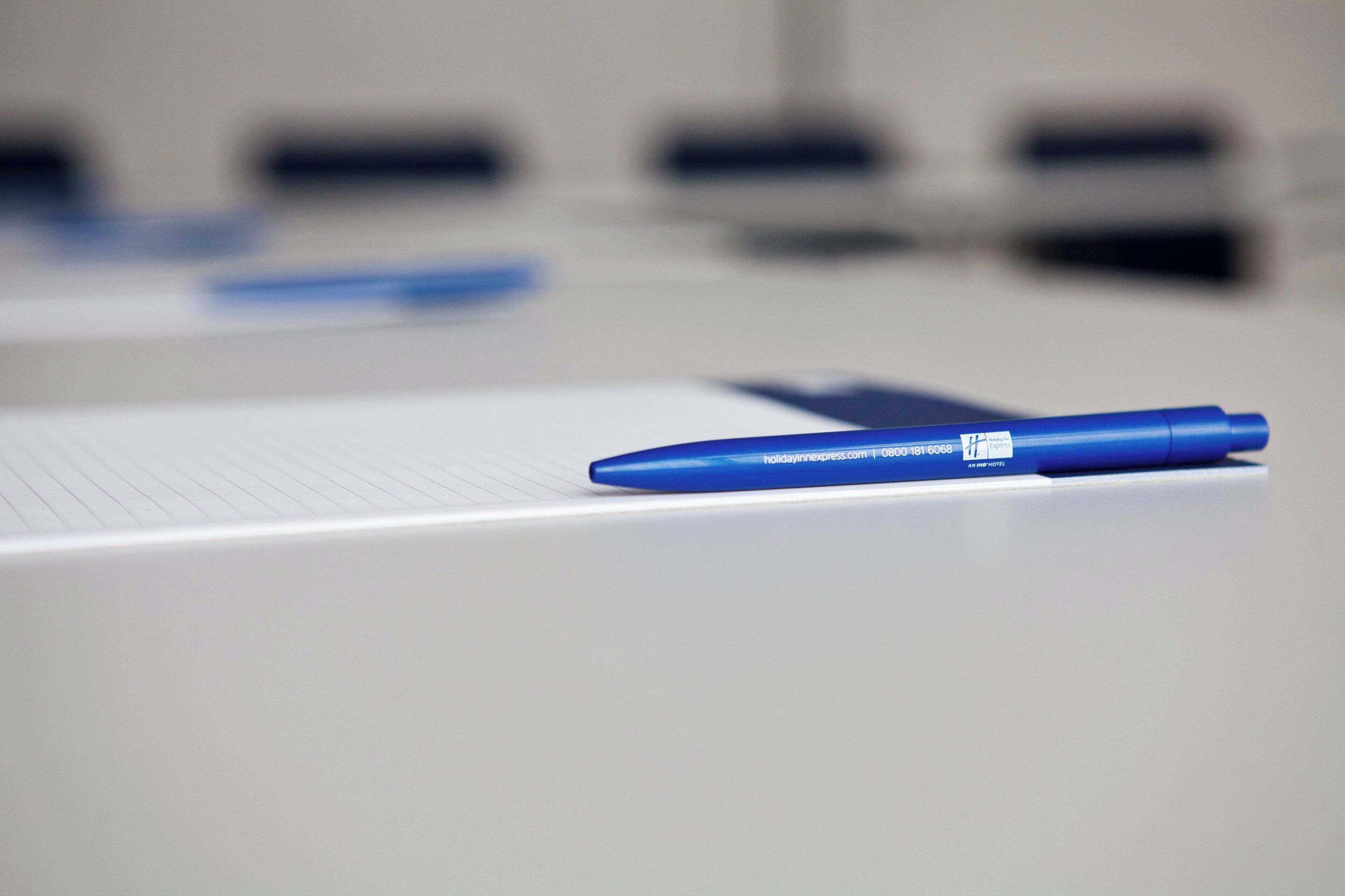 A pen on a notepad with a blurred background.
