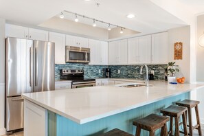 Fridge, dishwasher, coffee/tea maker, cookware/dishes/utensils