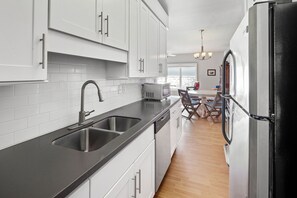 Fridge, dishwasher, coffee/tea maker, cookware/dishes/utensils