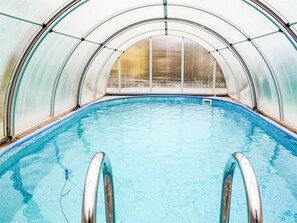 A swimming pool with a glass ceiling, surrounded by metal railings. - Vacation home Zásada by Interhome (Zasada)