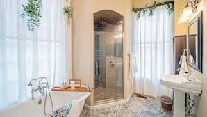A bathroom with a bathtub, shower, and sink.