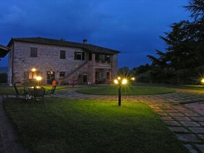Traditional stone building with a symmetrical facade and central entrance.