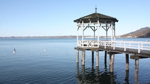 A gazebo on a pier over calm water with birds flying nearby. - Charming Apartment "Bregenz 6 Top 1" in Central Location with Wi-Fi, Terrace & Garden (Bregenz)