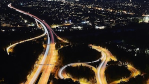 An aerial view of a complex highway interchange at night with multiple lanes and traffic flow. - Charming Apartment "Bregenz 6 Top 1" in Central Location with Wi-Fi, Terrace & Garden (Bregenz)