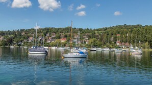 A calm lake with several boats docked, surrounded by a residential area with houses and greenery. - Cozy Holiday Apartment "Alina" with Garden Seating, Wi-Fi, Non-Smoking (Singen)