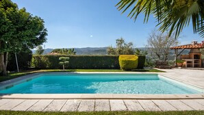 A rectangular swimming pool with a clear blue water surface, surrounded by a paved deck. - Holiday Home Casa do Valado with Mountain View, Pool, Wi-Fi & Garden; Parking Available (Resende)