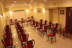 A conference room with a long table and multiple chairs.