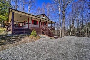 A two-story building with a porch and a staircase leading to the second floor. - Walk to New River Access! Family Cabin w/ Deck (Piney Creek)