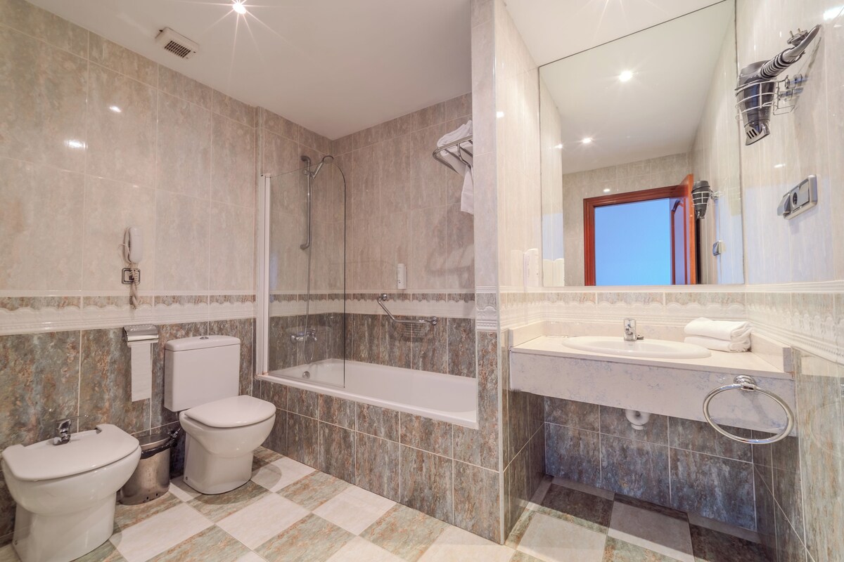Ein Badezimmer mit Badewanne, Toilette und Waschbecken.