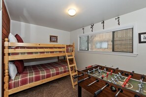 A bunk bed with a ladder, a foosball table, and a window with blinds. - Welcome to Bearadise by Destination Big Bear : Mountain Retreat in Lower Moonridge! Foosball! Walk to the Zoo & Golf Course! (Big Bear Lake)