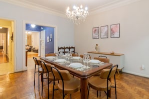 A dining area with a wooden table set for six, surrounded by six chairs. - 2 Minutes From Copacabana Beach A306 (Rio de Janeiro)