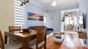 A modern living room with a wooden dining table, a sofa, and a ceiling fan. - Copacabana Ideal for Couples Rpp913 (Rio de Janeiro)