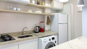 A modern kitchen with a granite countertop, stainless steel appliances, and a built-in washer and dryer. - 6 Minutes From Copacabana Beach Br1033 (Rio de Janeiro)