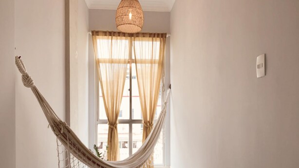 A room with a hammock, a window with curtains, and a hanging light fixture. - 6 Minutes From Copacabana Beach Br1033 (Rio de Janeiro)