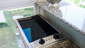A kitchen with a built-in stove and granite countertops.