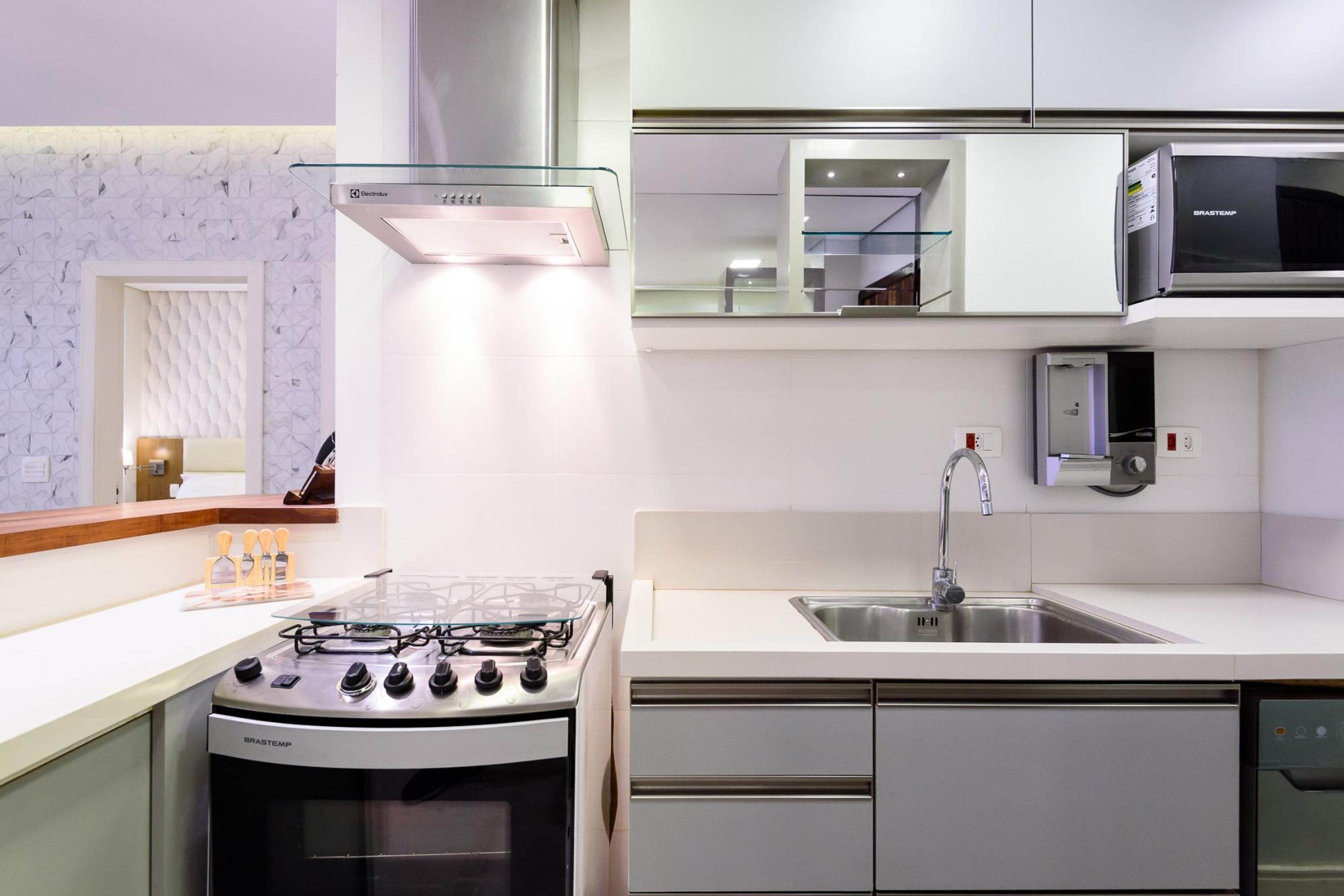 A modern kitchen with a gas stove, stainless steel appliances, and a dishwasher.