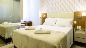 A hotel room with a bed, a bedside table, a nightstand, a mirror, and a wall with a geometric pattern. - 2 Minutes From Copacabana Beach Nsc601 (Rio de Janeiro)