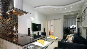 A modern kitchen with a glass island, stainless steel appliances, and a flat-screen TV. - 800m From Copacabana Beach Bc101 (Rio de Janeiro)