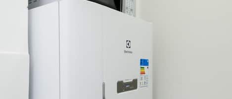 A white refrigerator with a digital display and a control panel on the door.