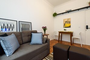 A modern living room with a sofa, a coffee table, and a dining area with chairs and a table. - 6 Minutes From Ipanema Beach Gc707 (Rio de Janeiro)