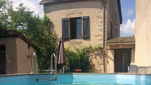 A swimming pool with a house in the background.