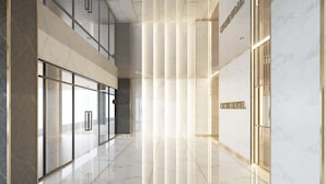 A modern hotel lobby with marble floors, glass doors, and a vertical light feature. - Hermann Hotel Pattaya (Pattaya)