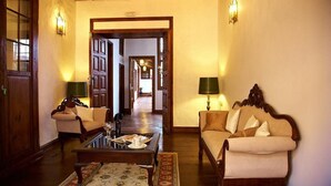 A traditional hotel lobby with wooden furniture, a coffee table, and two lamps. - Emblematico San Agustin Hotel (Icod de los Vinos)